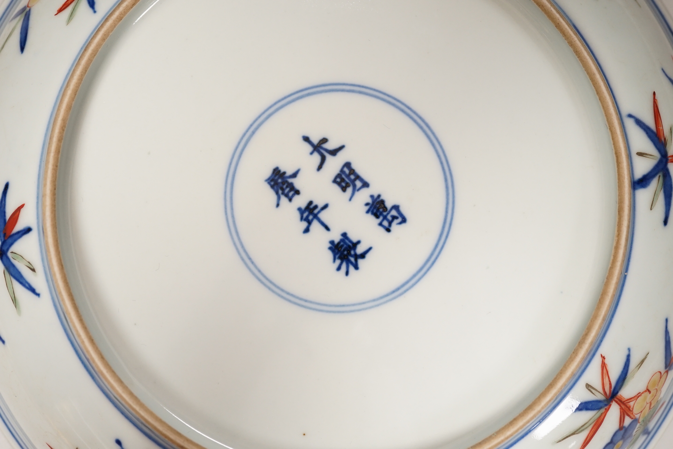 A Chinese wucai shallow dish hand painted with figures and flowers, housed in a fitted case, 23cm in diameter